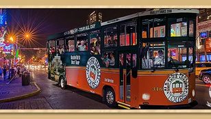 Nighttime charm: Old Town Nashville Hop-On, Hop-Off Trolley bus glides through the city, illuminated by enchanting lights.